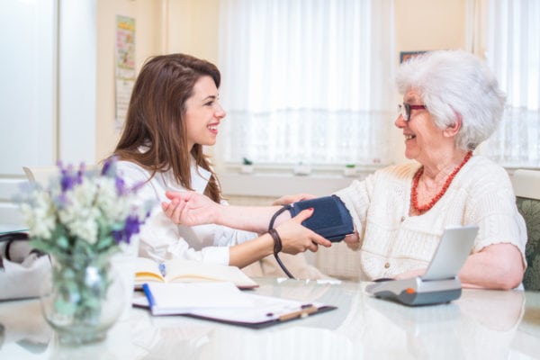 nurse_caring_elderly_woman_at_home