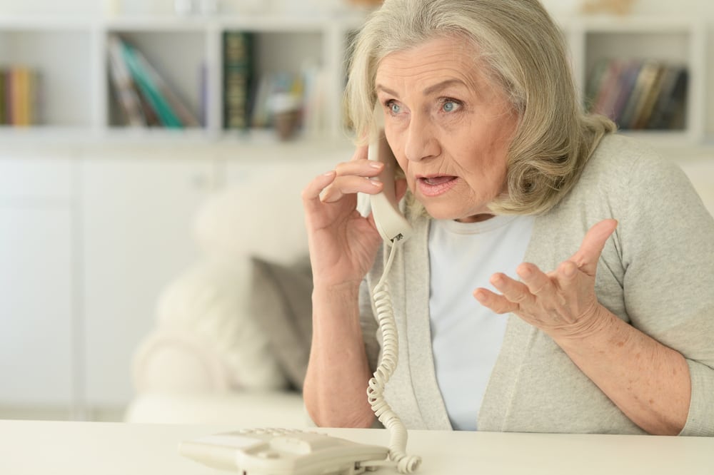 elderly_woman_concerned_on_phone