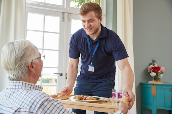 Care Provider Helping Elderly Man
